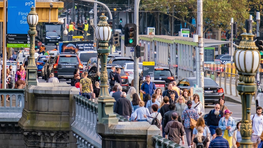 A picture of pedestrians walking over a bridge in Melbourne