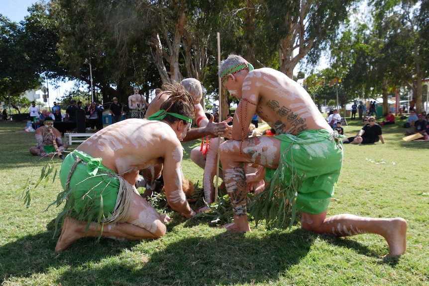 Indigenous people perform a smoking ceremony at Townsville