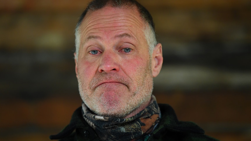 A headshot of a man with tears in his eyes.