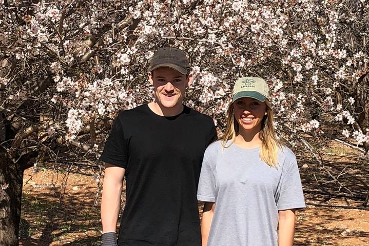 Backpackers on almond farm