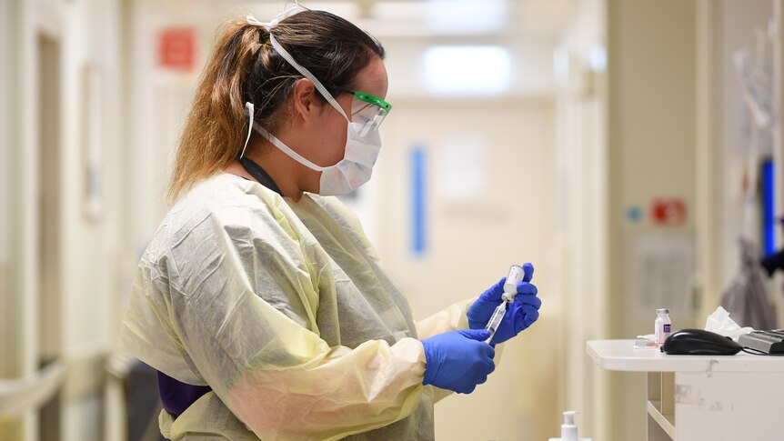 a nurse preparing an injection