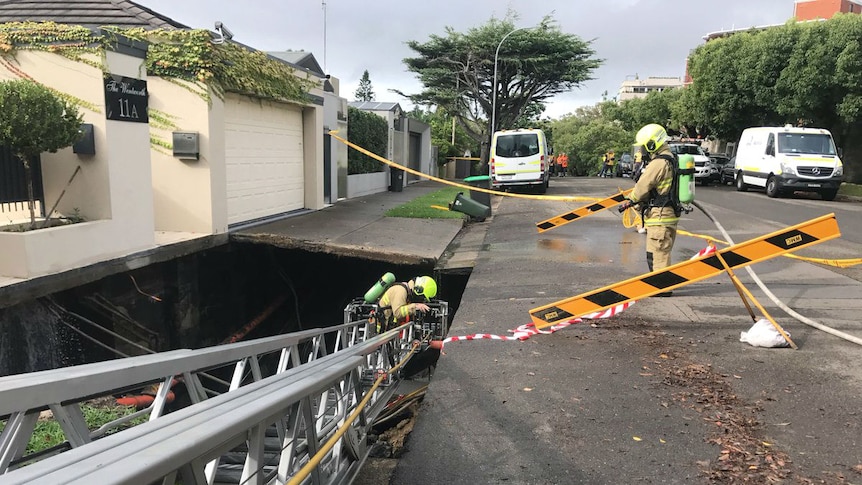 Fire investigators working on a sink hole at Point Piper in Sydney.