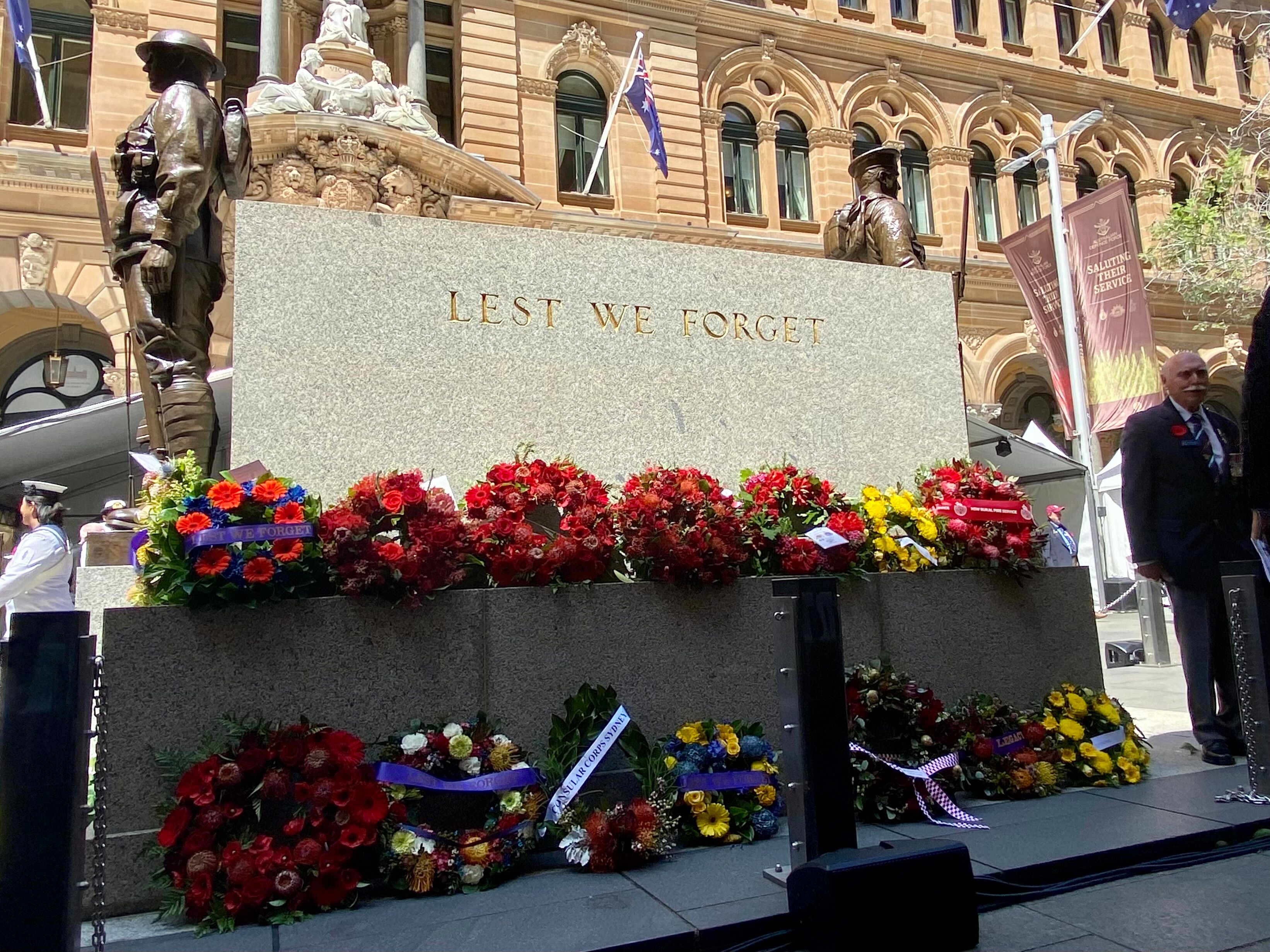 Floral wreaths laid at a cenotaph.