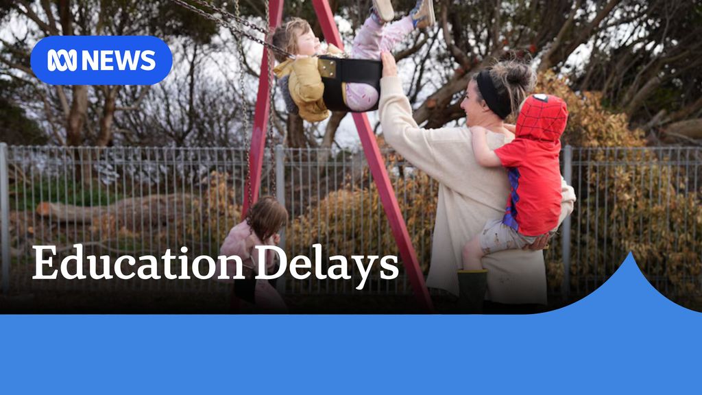 Education Delays: A woman with a child on her back pushes a swing with another child in it.