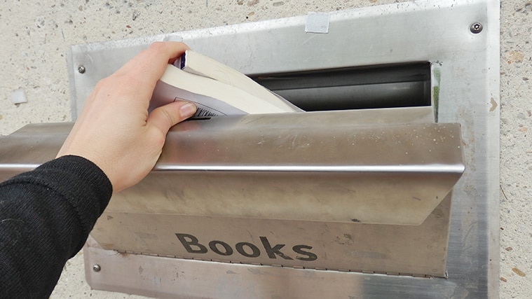 Library books are placed into a returns chute.