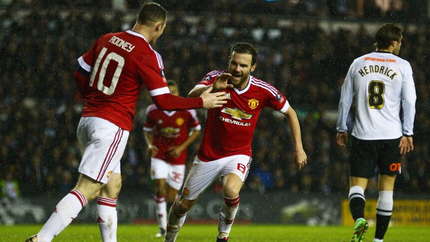 Manchester United's Juan Mata (R) celebrates a goal with Wayne Rooney in FA Cup tie against Derby.