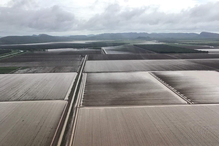 Aerial of flooded farmland with hills in background