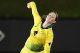 Amanda-Jade Wellington with the ball in the back of her hand as she bowls for Australia against England in an ODI.