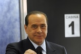 Silvio Berlusconi casts his ballot at a polling station in Milan