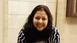A woman on Indian heritage smiling. 