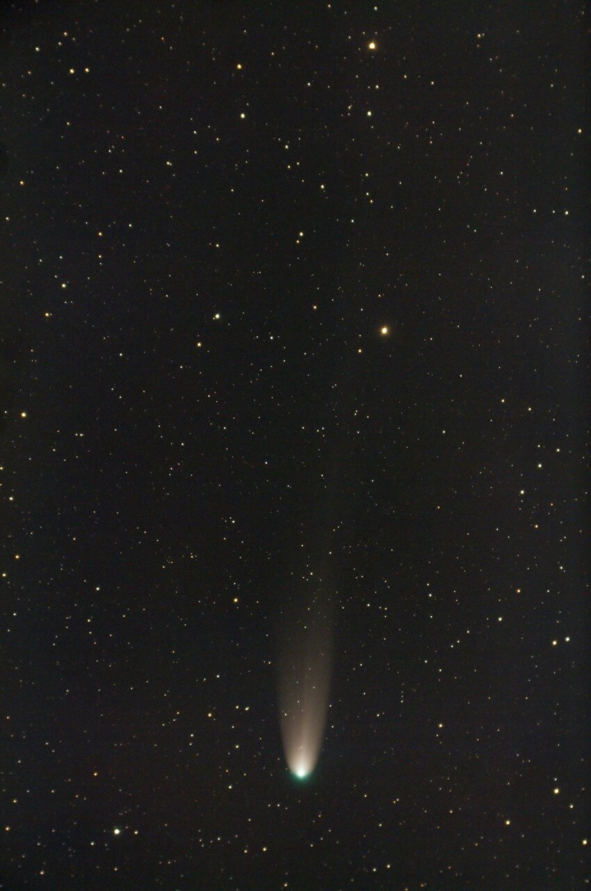 A circle of light against a black star speckled backdrop.