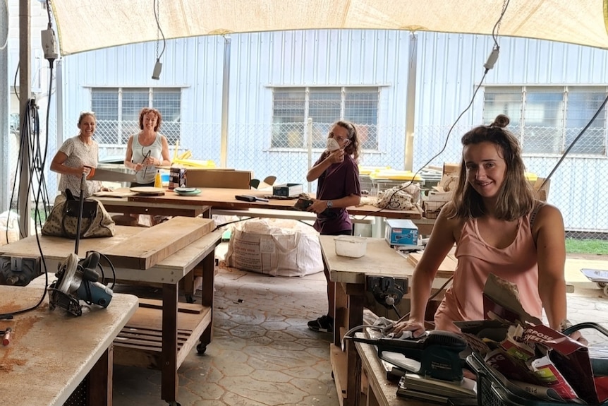 Women at work benches using power tools