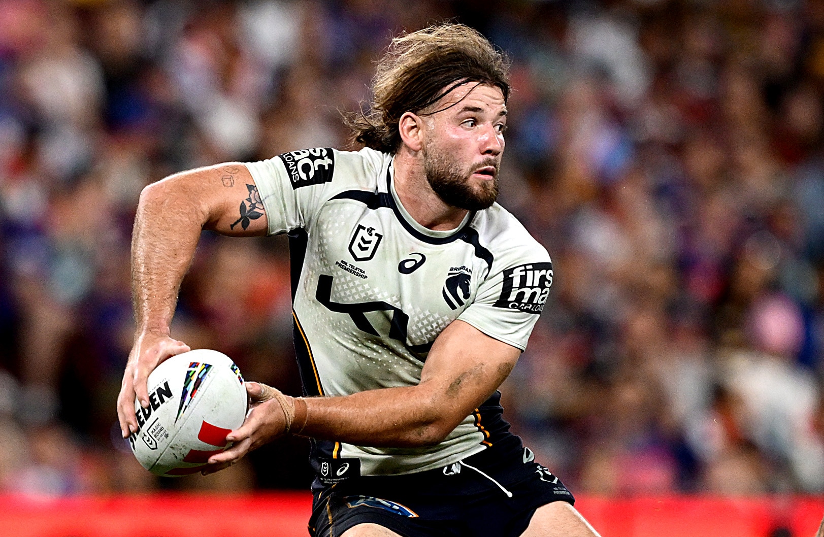 Patrick Carrigan prepares to pass the ball for the Broncos during a 2026 NRL match.