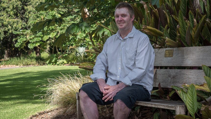 John Weeks sits on a bench in the Adelaide Botanic Gardens.