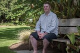 John Weeks sits on a bench in the Adelaide Botanic Gardens.