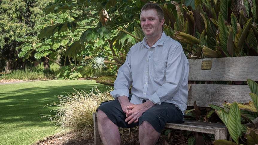 John Weeks sits on a bench in the Adelaide Botanic Gardens.