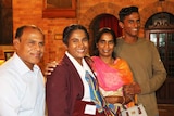Soumiga Gopalakrishnan, dressed in her school uniform, with her family at her graduation mass in Brisbane.