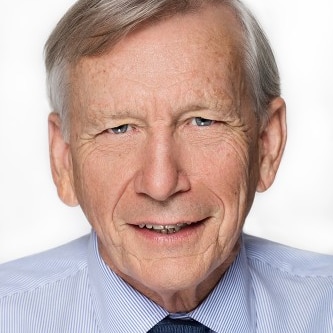 Man wearing a tie and smiling.