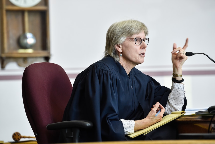 Judge Kathy Seeley sits in a Montana courtroom in her black robes and speaks into a microphone