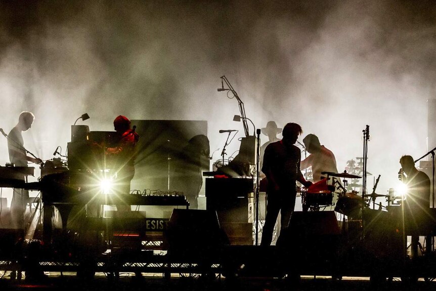 A silhouette of LCD Soundsystem performing at Splendour In The Grass 2017