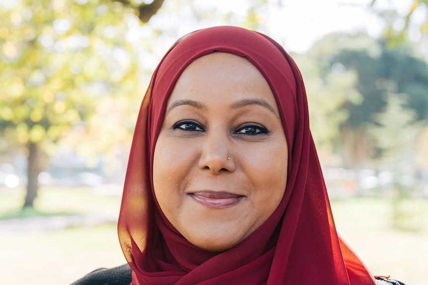 A photo of Inaz Janif wearing a dark red hijab.