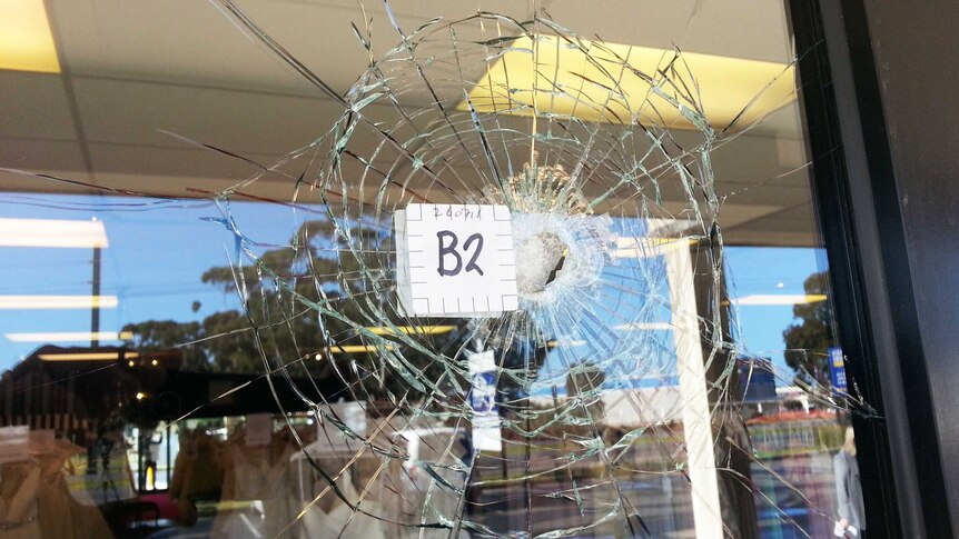 Business window with a bullet hole