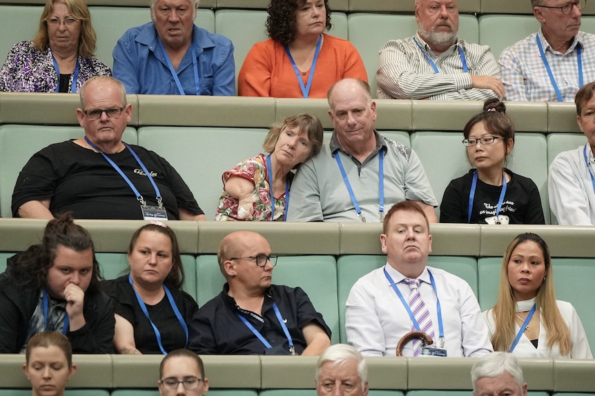 Thalidomide survivors and their families listen to the national apology