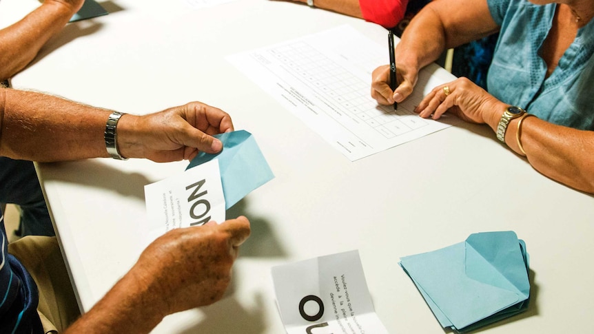 Polling station officials count the votes as part of the independence referendum in Noumea, New Caledonia's capital.