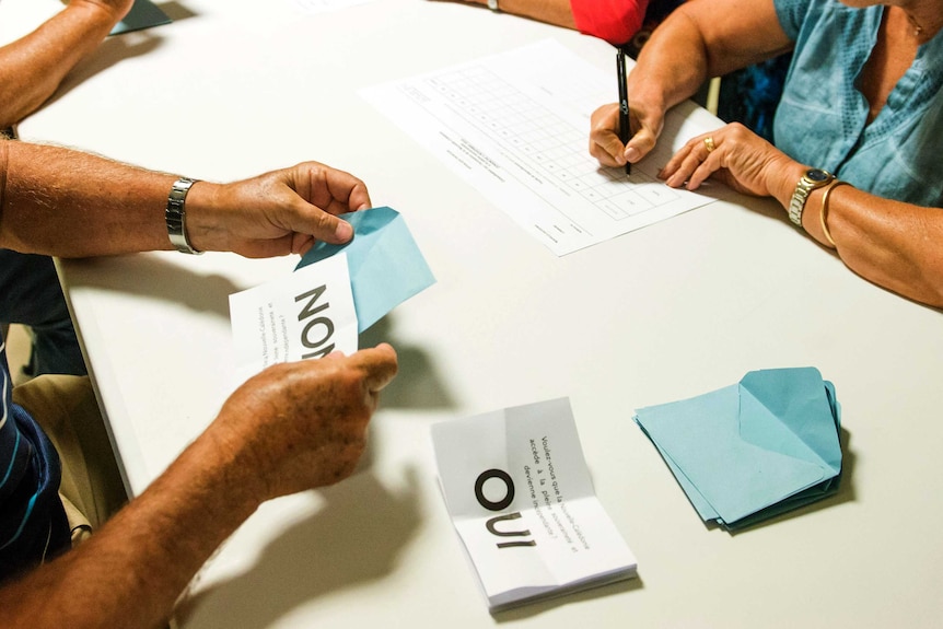 Polling station officials count the votes as part of the independence referendum in Noumea, New Caledonia's capital.