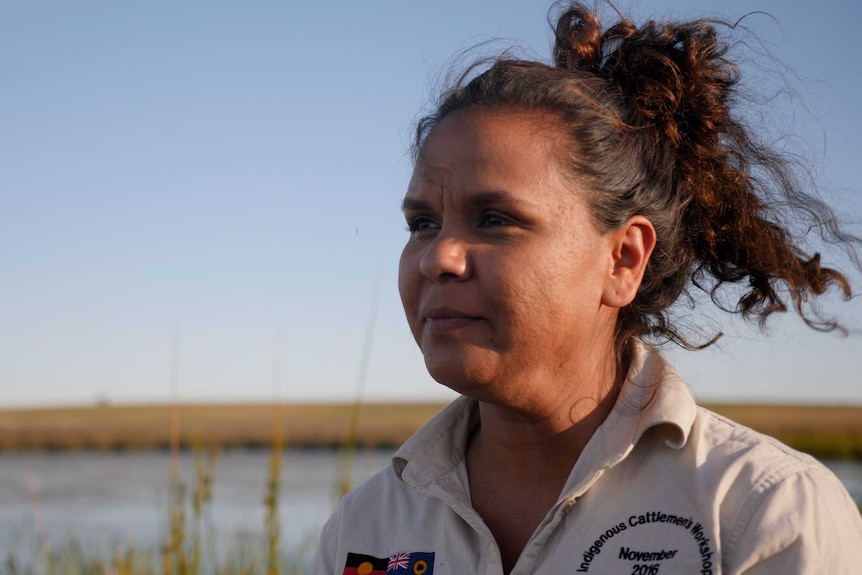Aboriginal woman Madeline Anderson overlooking a waterhole and paddock at Yallalie Downs in Dandaragan.