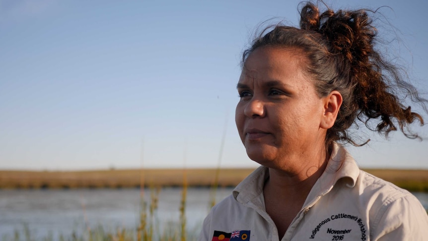 Aboriginal woman Madeline Anderson overlooking a waterhole and paddock at Yallalie Downs in Dandaragan.