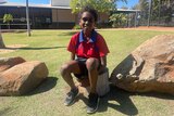 Aboriginal boy Jayden Hubert sits in his school's new yarning circle. 