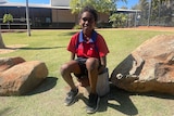 Aboriginal boy Jayden Hubert sits in his school's new yarning circle. 