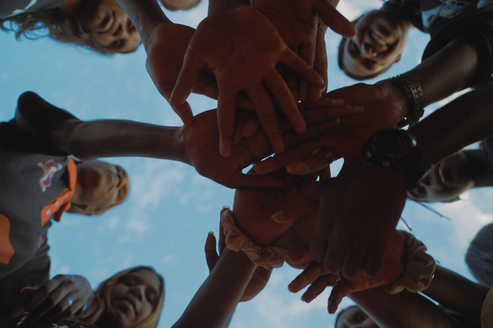 Hands against blue sky