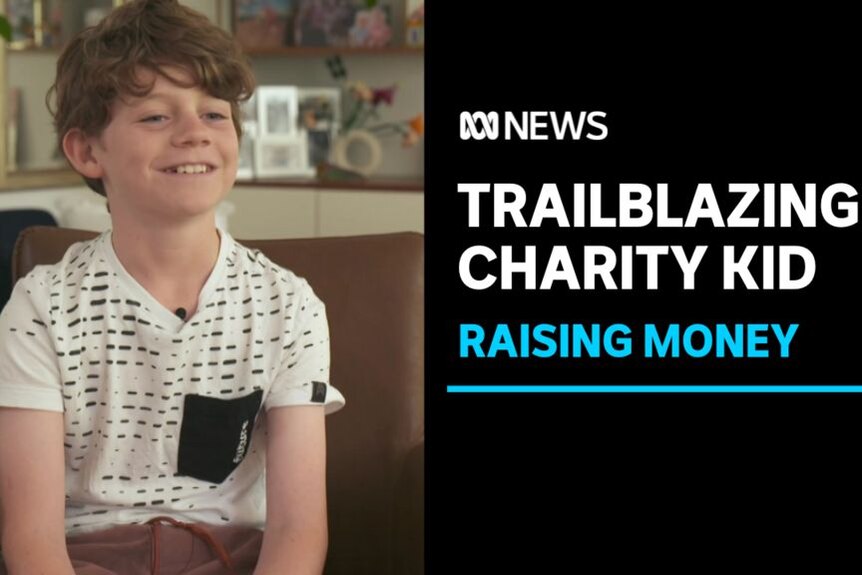 Trailblazing Charity Kid, Raising Money: Light brown haired boy sits on brown sofa smiling in front of family picture frames. 