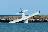 Image of a crashed aircraft sitting in the water off the Abrolhos Islands.