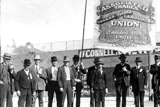 Men standing with a trade union banner in Broken Hill.