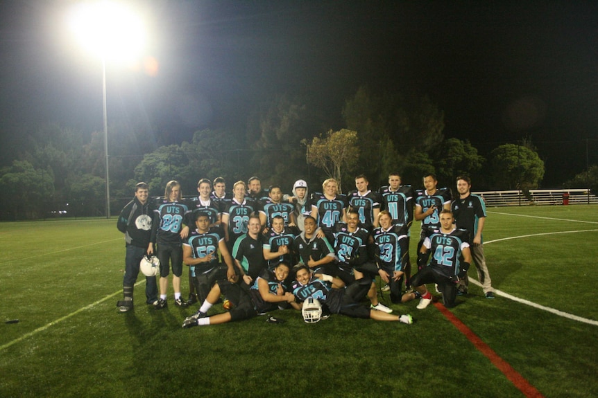 Night photo of football team under bright lights