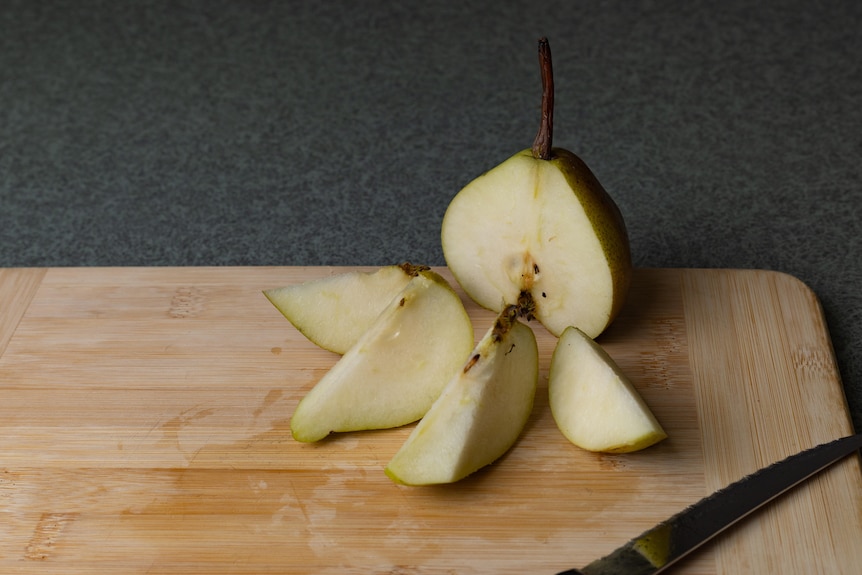 A pear cut into quarters 