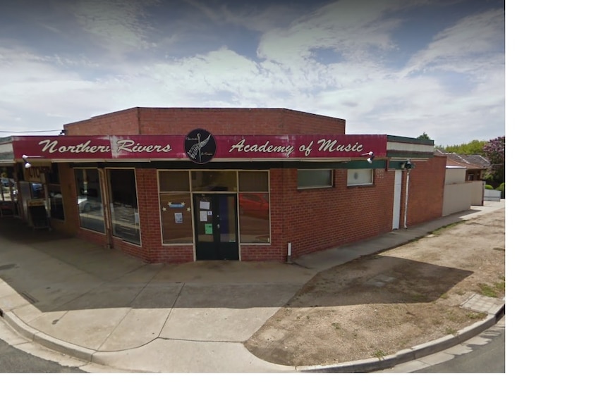 A brick building with a red sign