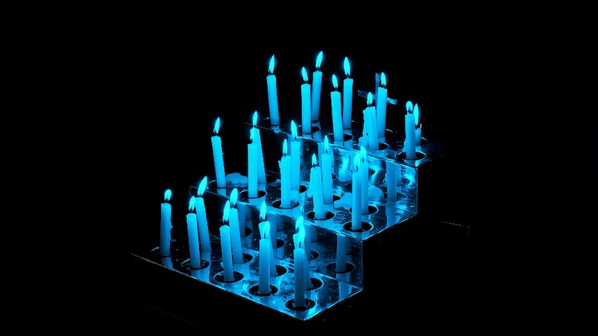 Candles under a blue light at Saint Peter's Cathedral