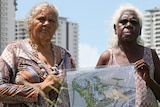 A photo of Larrakia elder June Mills and One Mile Dam resident Mindy Timber holding a draft development plan.