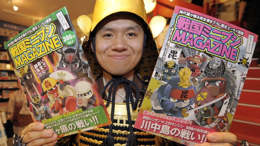 Growing craze: A shop clerk displays Manga comic books featuring the history of warloads.