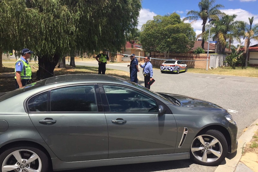 Investigating police officers in a discussion on the street where a woman was run over and killed.