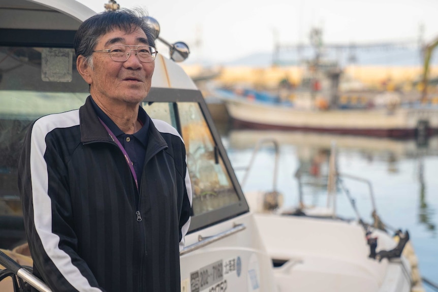 A shot of a 71-year-old man aboard his boat in a port