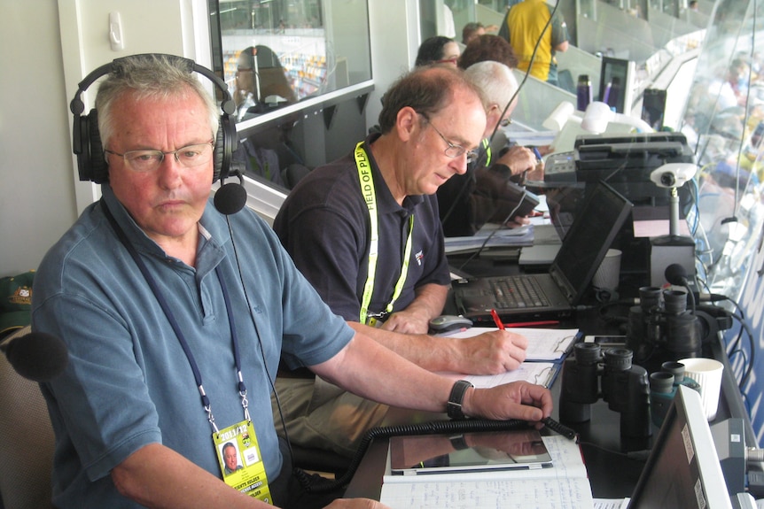 Drew Morphett in the commentary box at the Gabba with ABC Grandstand statistician Ric Finlay.