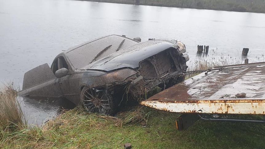 Subaru Liberty being pulled from a river.