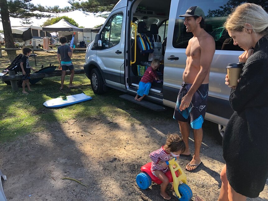 Travellers Peter and Hayley McGregor with their four boys at their van at a Crescent Head, NSW.