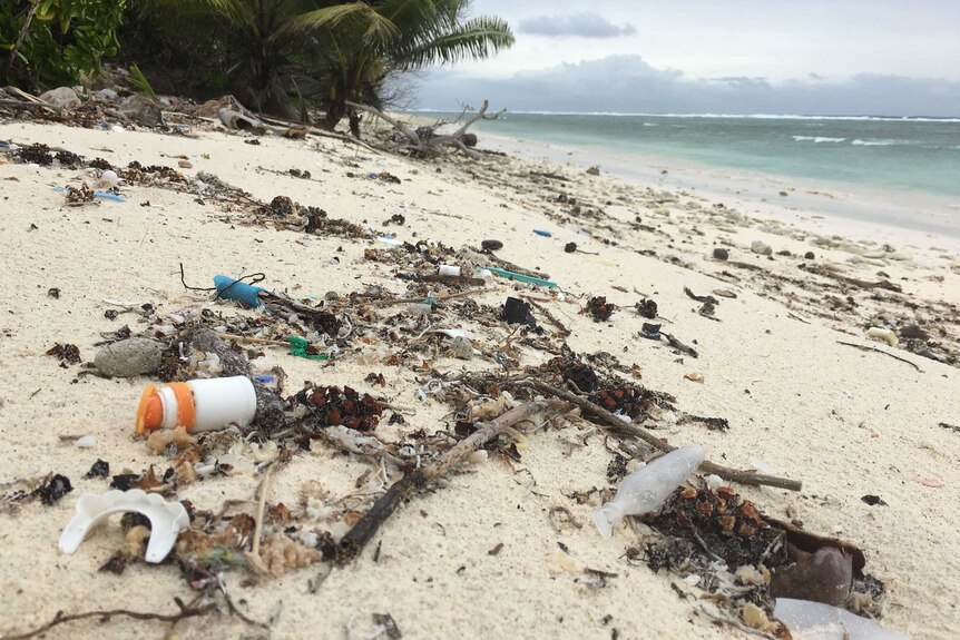 Close up of plastic debris and rubbish on a Cocos Island beach
