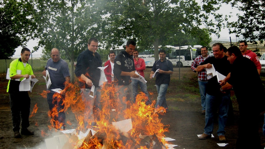 Young men burn copies of the guide to the Murray-Darling Basin plan